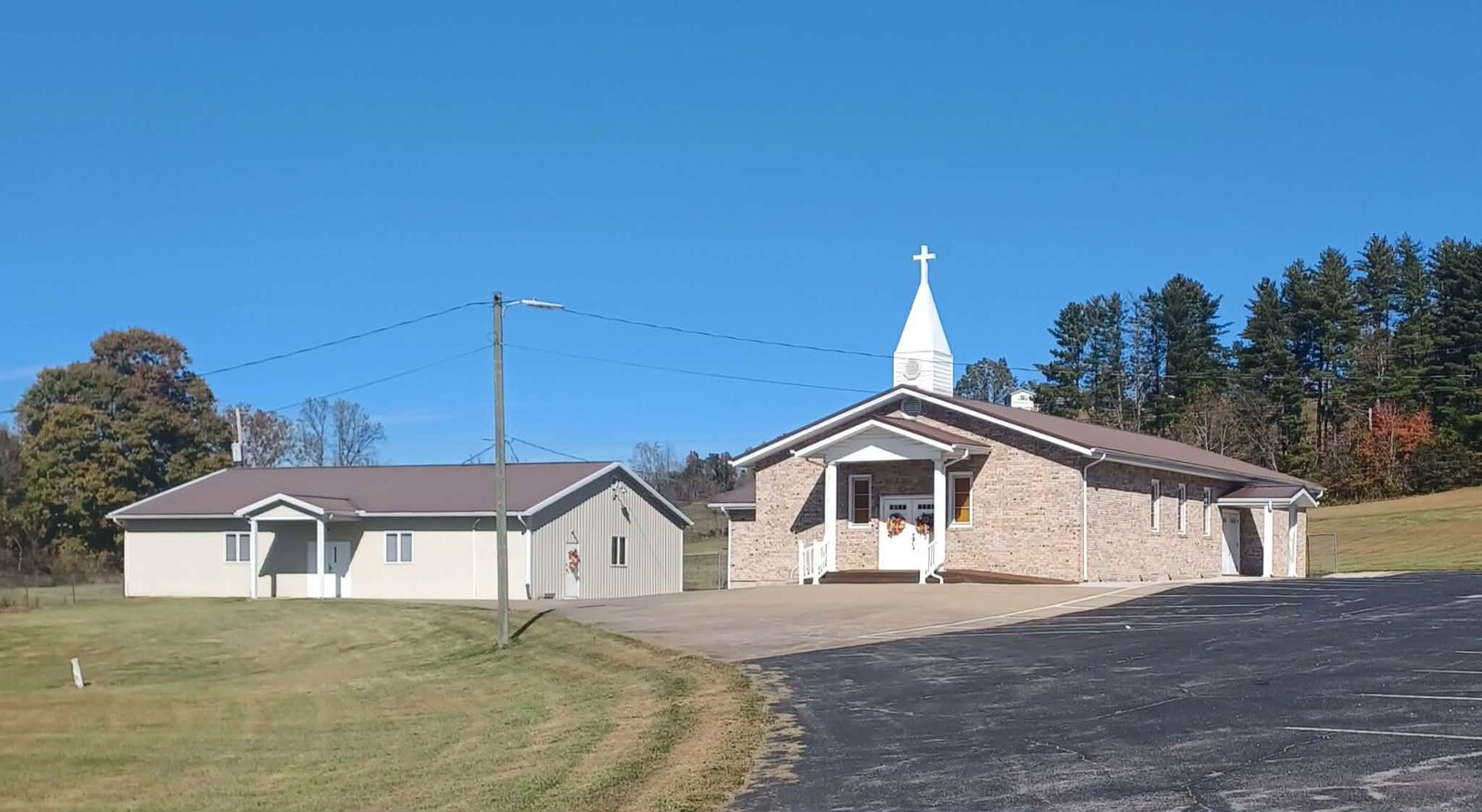 Flat Gap Baptist Church, a brick building with a white steeple, on Flat Gap Drive